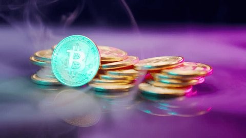 clip-4000298737-close-up-view-stack-bitcoin-coins-reflecting-colorful