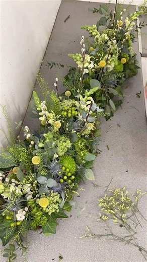 🌿 Natural Elegance, Thoughtfully Made 🌿 This fresh and textural hedgerow-style arrangement was created using Oasis FibreFloral—a sustainable base made from volcanic basalt rock in a compostable tray. Designed to sit on a rustic wicker coffin, it’s brimming with seasonal greenery, eucalyptus, craspedia, pussy willow, thistles and soft snapdragons, all nestled into moss. Crafted in individual sections, each piece can be taken home by family members after the service — allowing the flowers, and t
