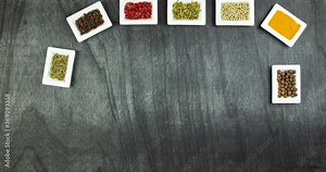 Spices and herbs. Seasoning move on a wooden table and write words. Stop motion animation spices mix. Cooking animation of spices mixing. Process of spices and herbs mixing.