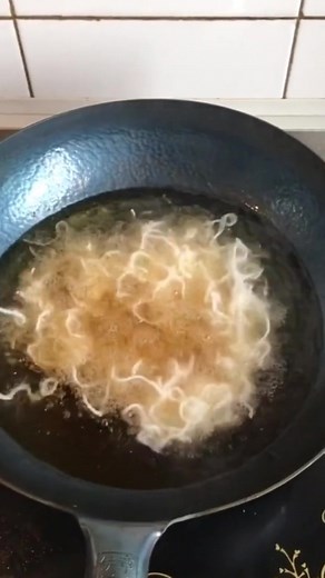 Freshly Cooked Stringy Noodles in a Black Frying Pan