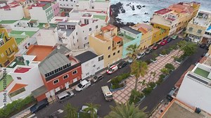 TENERIFE, PUNTA BRAVA, SPAIN - MAY, 18, 2018: Aerial view Atlantic ocean coast and colorful houses .