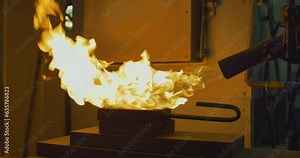 Hot fire is coming from the blow torch tool at the production facility. A Worker is using the blow torch tool that sprays hot fire. Aiming the torch tool with hot fire at the metal ingot. Metallurgy.