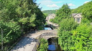 Aerial footage of Hebden Bridge a lovely old textile mill town on the Rochdale Canal in West Yorkshire England. Showing Locks, Canal Boats, Barges, and old world houses.