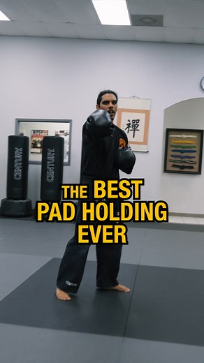 Master G teaches one of the best pad holding drills for movement, control, and range management. It’s not just about standing in one spot and throwing punches, both the pad holder and striker need to stay mobile and connected. The drill involves stepping forward or back while maintaining clean technique. It ends with a controlled power shot, requiring both partners to stay in range. Don’t have pads at home? No problem. Master G shows how to adapt the drill by reducing power and focusing on conta