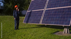 busy lady standing by the solarcell panel. brunette female works at solar heat plant. Stock Video