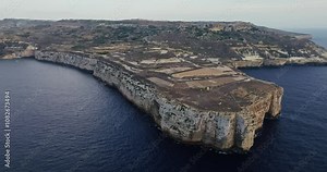 Aerial view of the rocky precipitous coast of the sea on the island of Malta. Nature landscape of the embankment in the Mediterranean Sea where the waves crash on the rocks. High quality 4k footage