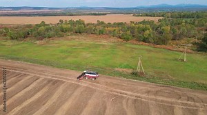 Autumn, 2020 - Primorsky region, Russia - Top view. The camera monitors a combine harvester in the field. Harvesting in the Russian field.