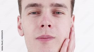 Troubled young man with a toothache problem applying a cold compress on to his hurting jaw