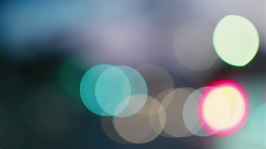 Bokeh colorful lights move and twinkle in the distance - Free Stock Video