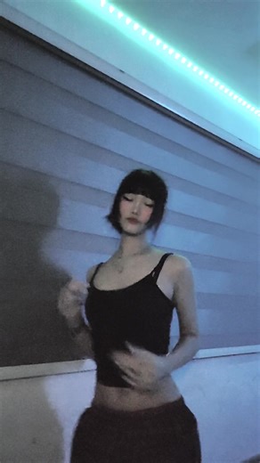 Dynamic Dance Movements in a Blue-Lit Room