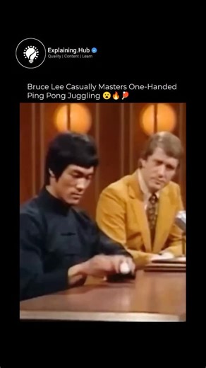 Explaining Everything on Instagram: "Is a short, colorized clip from Bruce Lee's famous 1971 interview on The Pierre Berton Show in Hong Kong. In it, a seated Bruce Lee casually juggles a ping pong ball one-handed with effortless precision and fluidity, bouncing it repeatedly off his palm while chatting calmly. It's gone massively viral (over 2 million views quickly) because the movement looks almost too smooth and perfect—leading to heated debates in the comments: half the viewers are in awe of