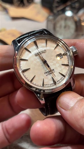 精工調酒師 這是一款SEIKO（精工錶）Presage 系列的「櫻吹雪」（Sakura Fubuki）限量版自動機械腕錶。此錶款以其獨特的白色紋理錶盤和藍鋼指針而聞名。 主要特色 系列: 屬於 Presage 系列，俗稱「調酒師系列」（Cocktail Time），靈感來自於日本銀座 Star Bar 的調酒師。 型號: 主要有兩個型號：SRPC03J1（國際版）和 SARY089（日本國內版），兩者通常功能相同。 限量發行: 該錶款為全球限量生產，例如 SRPC03J1 限量 3,500 只。 錶盤設計: 錶盤是其最大特色，具有精緻的放射狀凹凸壓紋，旨在捕捉櫻花在風中飛舞的動態美感，因此得名「櫻吹雪」。 機芯: 搭載可靠的 Seiko 4R35/4R36 自動上鍊機械機芯。 指針與時標: 醒目的藍鋼秒針與劍形時針形成對比，時標則為尖銳的 V 形設計。 其他: 錶殼直徑約 40.5 毫米，具有日期顯示窗，配備硬化處理的礦物水晶玻璃（Hardlex）鏡面。 由於其限量性質和獨特的錶盤美學，這款「櫻吹雪」在精工錶迷中具有相當的收藏價值。 @闆大琦妹「俗出名」 @我❤️527闆大&琦妹