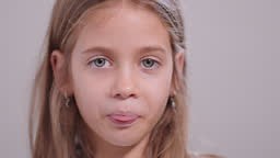 Pretty girl sticking out her tongue and teasing while looking at the...