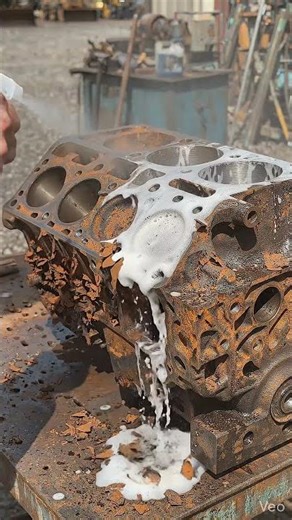 Hand cleaning rusted engine block