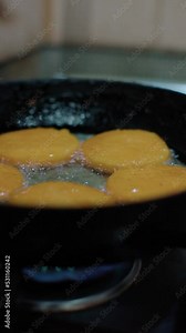 corn tortillas cooking in the frying pan with vegetable oil, closeup