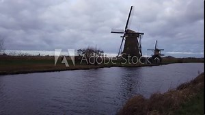 DOLLY SHOT - The windmills of Kinderdijk, Netherlands. Nineteen beautiful windmills, built around 1740, stand here as part of a larger water management system to prevent floods.