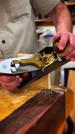 Smoothing the surface of a thick wood board using a professional hand plane for precision