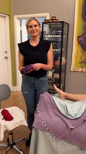 Hot towels are a fantastic addition to a massage session. Here Hillary is demonstrating the use of hot towels on the client’s feet. #massageschool #massagetherapist #massagetraining #massagetherapy | Denver Integrative Massage School