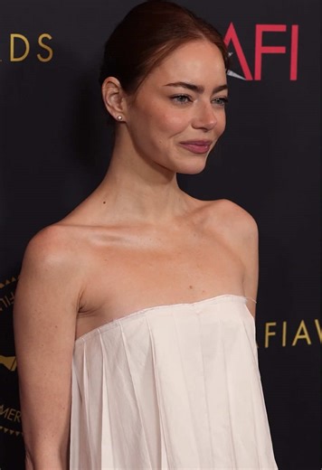 A pleated vision. Emma Stone wore Calvin Klein Collection to the AFI Awards Luncheon. Seen in a white poplin strapless hand-pleated top and matching belted skirt.