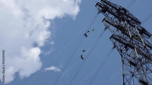 two people jumping from huge powerline pole with parachutes