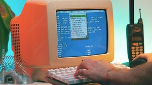 Using a vintage computer from the late 80s early 90s to work on a desk. Retro screen and background.