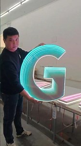 Infinity Glow: Holding the Luminous 'G' Sign ✨