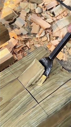 Splitting wood blocks with chisel along marked lines