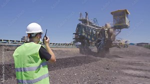 Coal loading in thermal power plant. The engineer is following the coal loading process.