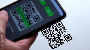 Hand using mobile smart phone scan QR code .QR code scanning payment and verification. Cashless technology and digital money concept.