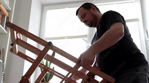 Man installing an easel for painting. Artist preparing his work space.