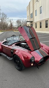 7.7K views · 12K reactions | The Ruby ❤️‍ Available Now - 1965 @backdraft_racing Cobra  - Ruby Red / Black Magic Stripes / Side Stripes - Diamond Stitch Interior - Iconic 427 V8 480HP - Power Steering - Autometer OEM Style Gauges - Remote Brake and Clutch Reservoirs - Blacked Out LED Headlights - 3M Paint Protection - Glove Box - Clear Front Turn Signals #JMCCobra #shelby #cobra ☎️609-871-2700 JMCCobra.com | Jonathan Motorcars | Facebook