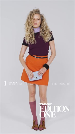 EDITION ONE: LOOK 1 Ludmilla • Contour Cut • Lumi Blush This Contour Cut highlights the beauty of natural curls, elevated with TONI&GUY’s signature Lumi Blush colour package. Hand-painted for a natural finish that enhances waves and curls with brightness, depth with soft blended tones. Illuminating Ludmilla’s natural features, while a deep side part and soft face framing create an effortlessly refined finish. Trend-led cuts and colours - ready to wear, ready to book. Stylist: British Hair Dresse