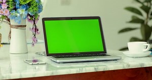 Laptop with key green screen.
