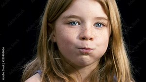 Young girl being silly and puffing our her cheeks