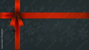 rectangular gift covered with dark christmas wrapping paper with soft snowflakes and a long red bow on the upper left corner