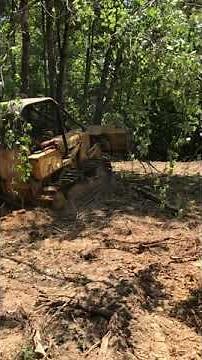John Deere 450c Pushing Out a Tree