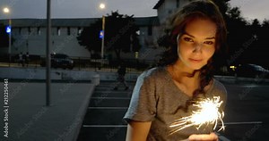 Teenage Girl With Sparkler Dancing In The Night Street In Front Of Parking Lot 4K