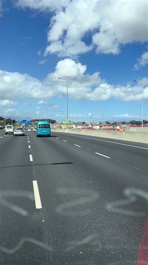 Blue Van Journey on Highway: Emergency Exit Signage
