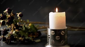 Burning Candle Flame with Withered Dry Flowers on Table on Black Background. Cloud of smoke, smog around a candle in the candlestick. Concept of memory, ritual, funeral, mourning, death anniversary. Stock Video