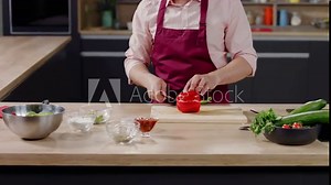 Cooking show host celebrity chef shows hot to cut pepper, broadcast TV programme. Shot on ARRI Alexa Mini