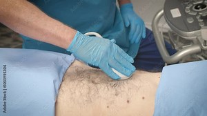 A sonographer performs an ultrasound inspection of the bowel and abdomen on a patient.