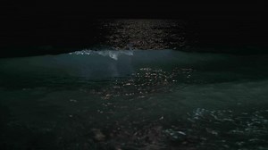 Night waterscape with waving sea rolling in on the shore