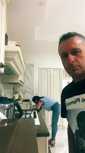 Couple's Affectionate Moments in a Modern Kitchen