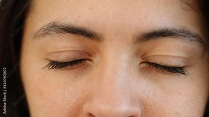 Close-up of woman closing and opening eyes in macro detail