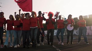Female football fans exulting while watching a soccer game at the stadium - Women with painted face and megaphone encouraging their team - Sport entertainment concept