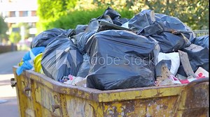 Overflowing garbage container on the street in 4k slow motion 60fps