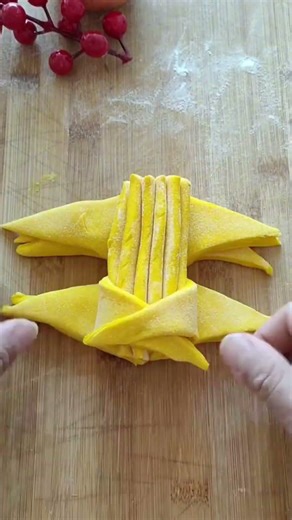 Making triangle shapes, stacking them, and forming them into a corner flower pattern neatly by hand.