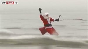 We're used to seeing Father Christmas in a sleigh - but today Santa and his reindeer took to the waves on the Potomac River near Washington DC. | Sky News