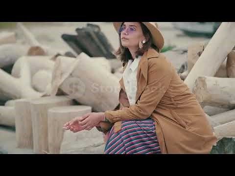 Pensive woman smoking cigarette at rooftop bar during night