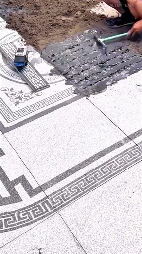 laying floor tiles with intricate patterns using mortar and laser level for precision and alignment